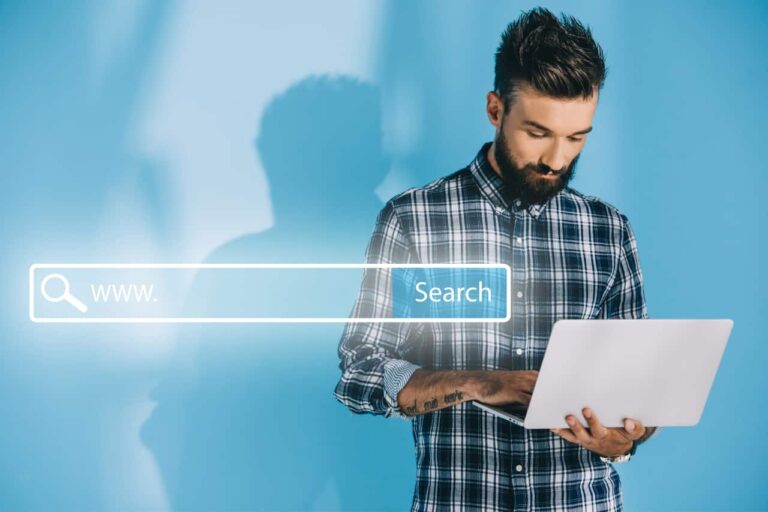 Soar man standing with laptop in hand typing with search bar superimposed